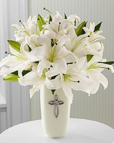 <p>When words fall short, this serene and meaningful all-white arrangement offers a way to express your heart. Symbolizing purity, peace, and enduring love, it is perfect for honoring life’s sacred moments or comforting someone during a time of reflection.</p>
<p>Featuring radiant white lilies, this bouquet is arranged in a white ceramic vase and accented with a decorative cross, adding a spiritual touch to its graceful presence. The design is all-around, making it ideal for placing on a table, altar, or memorial display.</p>
<p>This arrangement is a fitting choice for religious celebrations, confirmations, sympathy tributes, weddings, or special anniversaries. Its clean lines and symbolic elements create a timeless and respectful presentation for life’s most meaningful occasions.</p>
<p>Each bouquet is handcrafted with care to ensure freshness and beauty. Same-day delivery is available to bring your thoughtful gift promptly and with respect.</p>
<p>Add a heartfelt message at checkout to personalize your delivery. Send more than flowers—share faith, comfort, and timeless beauty with a graceful tribute that will be remembered.</p>